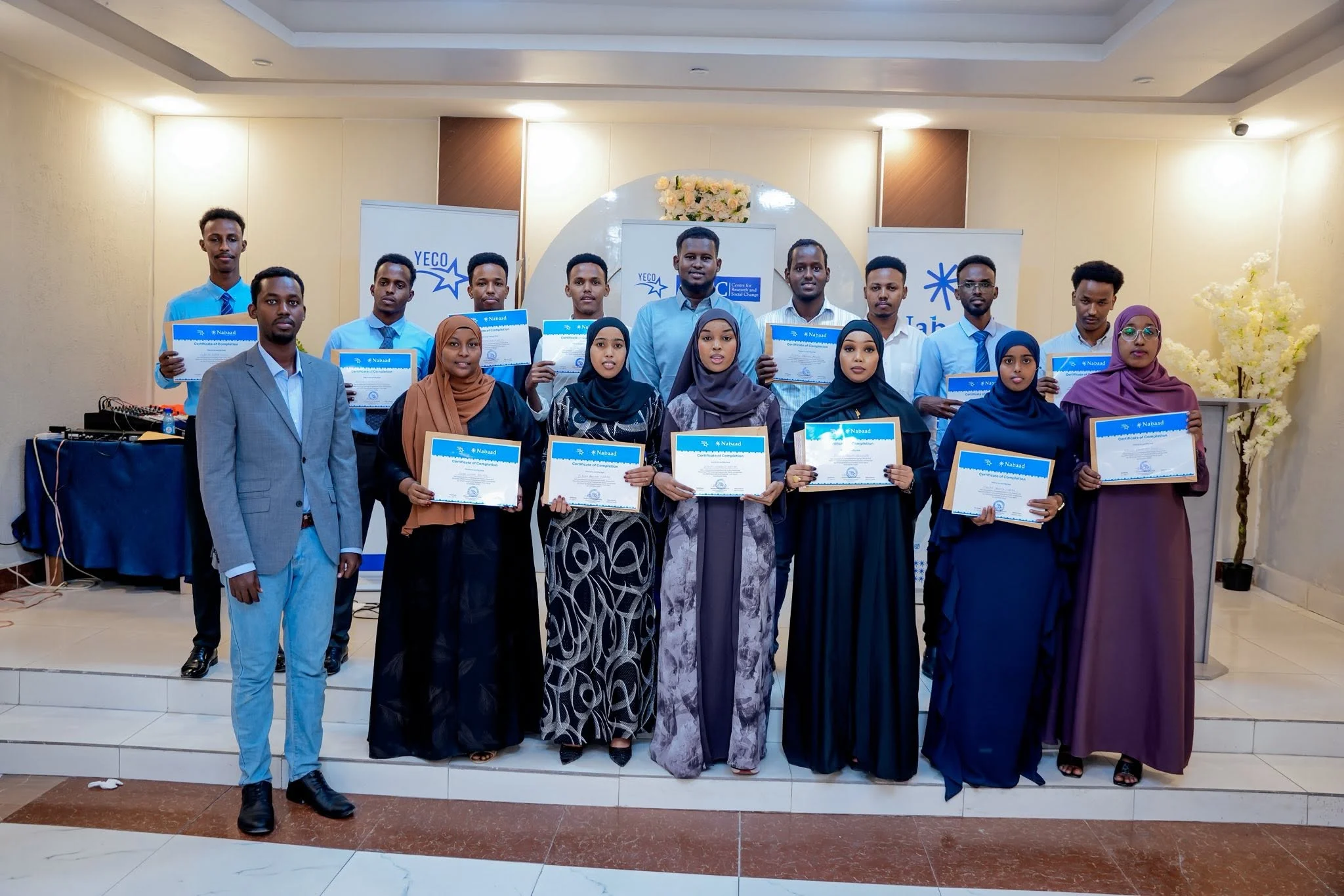 Young people holding their certificates after a training workshop