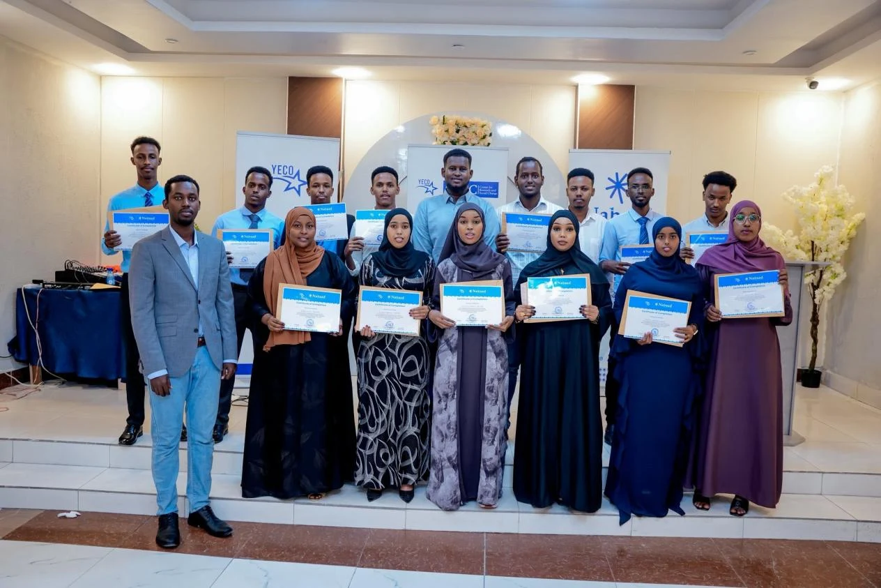Young people holding their certificates after a training workshop
