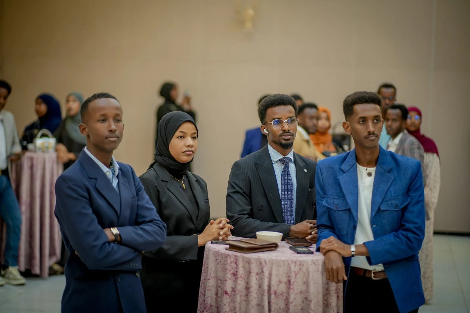 Young people listening and taking notes at a forum